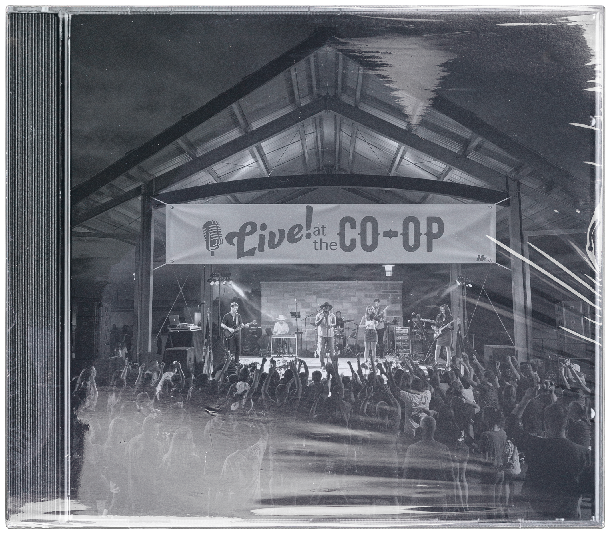 Crowd at a past Live at the Co-Op show, band performing under the venue's metal roof